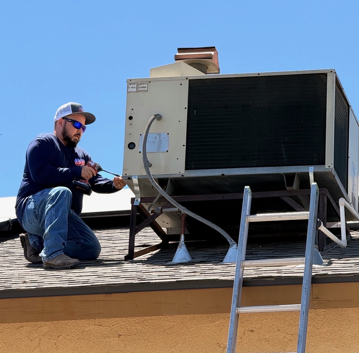 A&G Heating & Air technician servicing a rooftop HVAC unit in Fresno